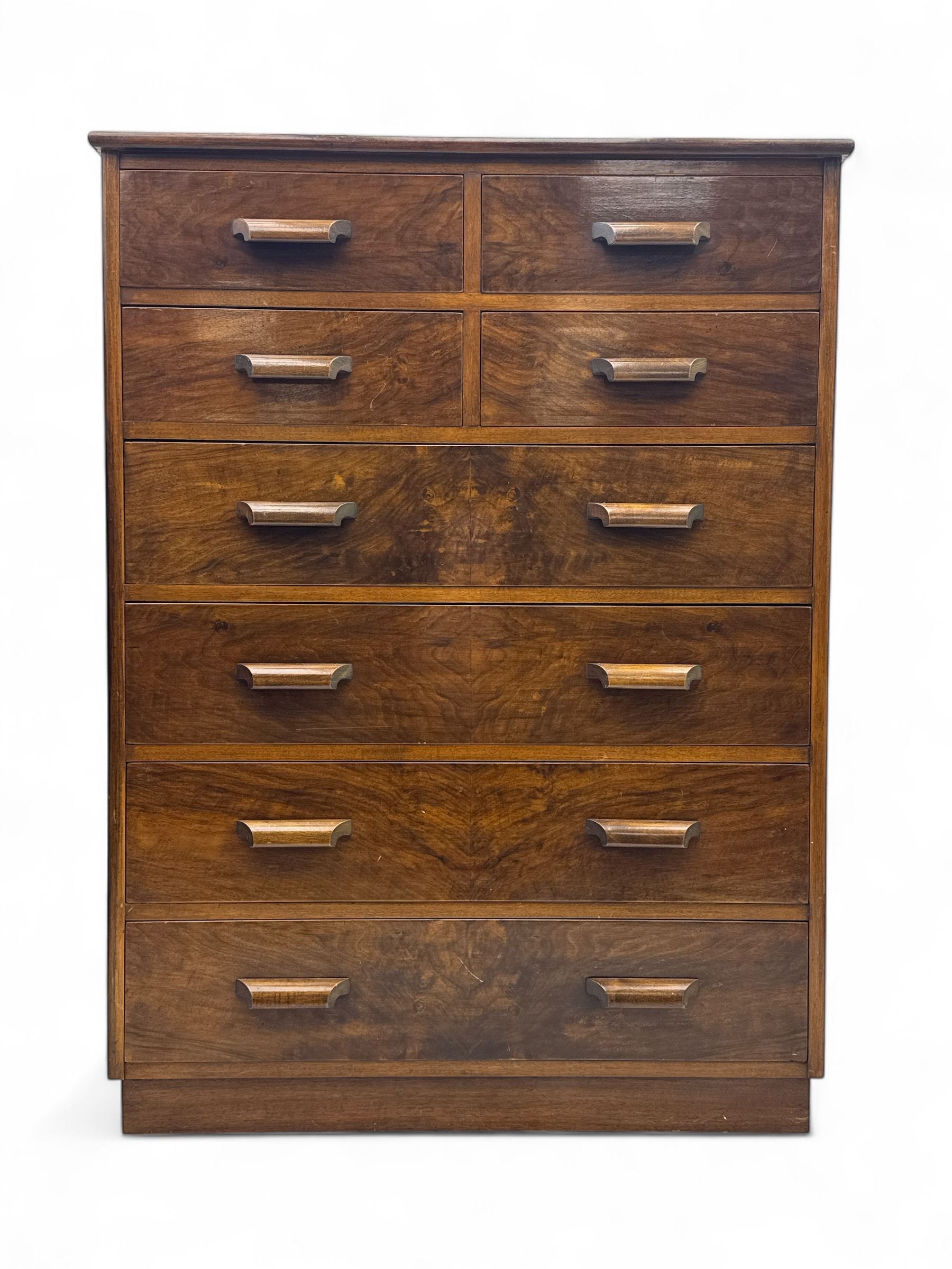 Early 20th century walnut chest, fitted with four short and four long drawers, on recessed plinth base