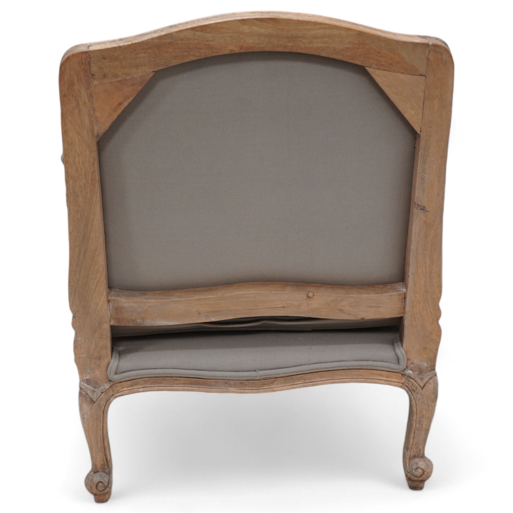 Louis XV design limed hardwood framed open armchair, upholstered in pale taupe fabric with loose seat cushion, raised on cabriole supports with scroll feet