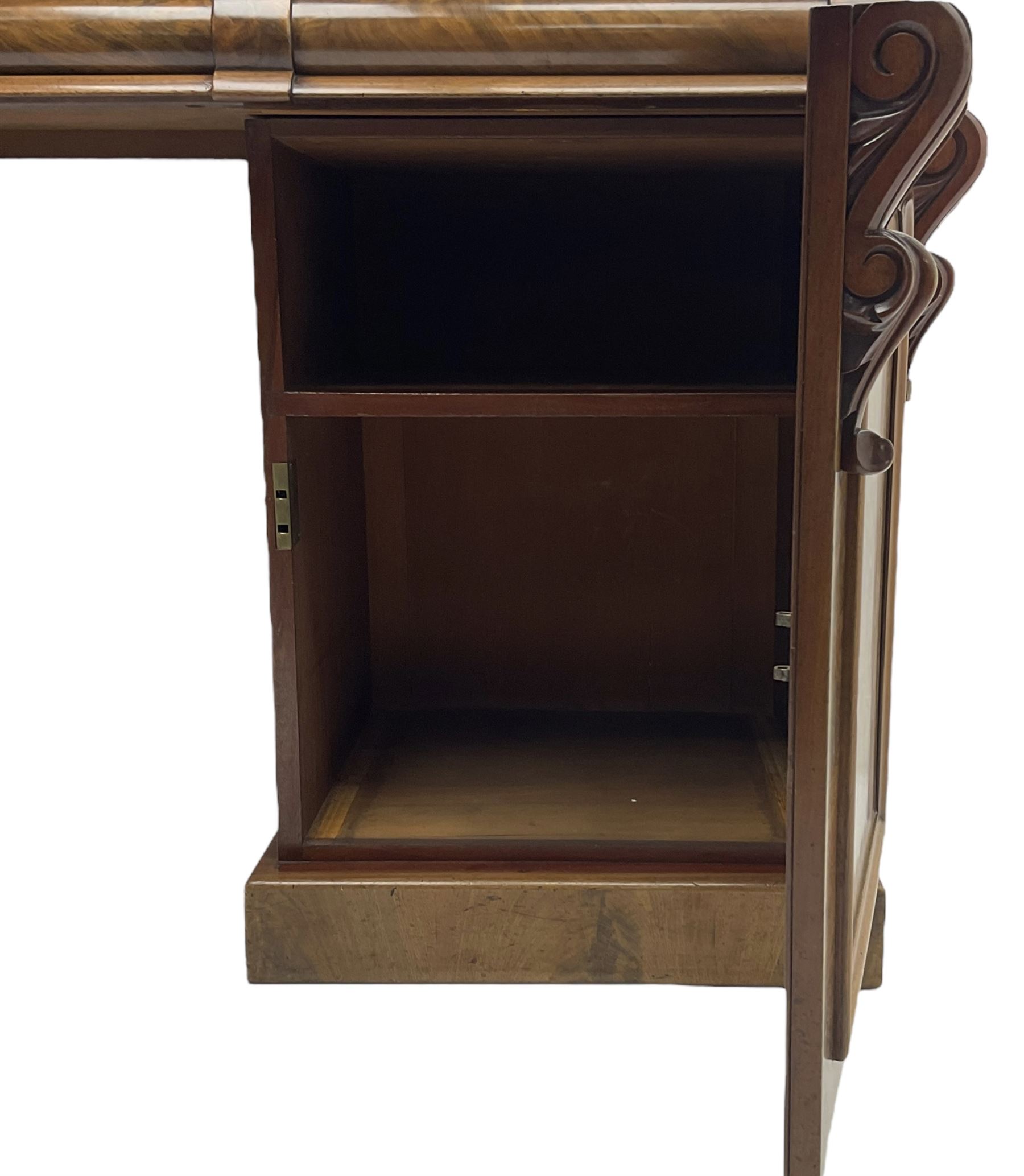 Victorian mahogany twin pedestal chiffonier, raised back with decorated with scrolling foliate motifs, fitted with three cushion drawers, the arched panelled pedestals enclosing shelves and sliding trays