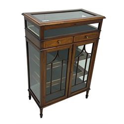 Edwardian mahogany bijouterie display cabinet, featuring satinwood inlay and crossbanding, hinged glazed top fitted with two banded drawers, over two astragal glazed doors enclosing black wool baize lined shelves with gold trim, supported by spade feet