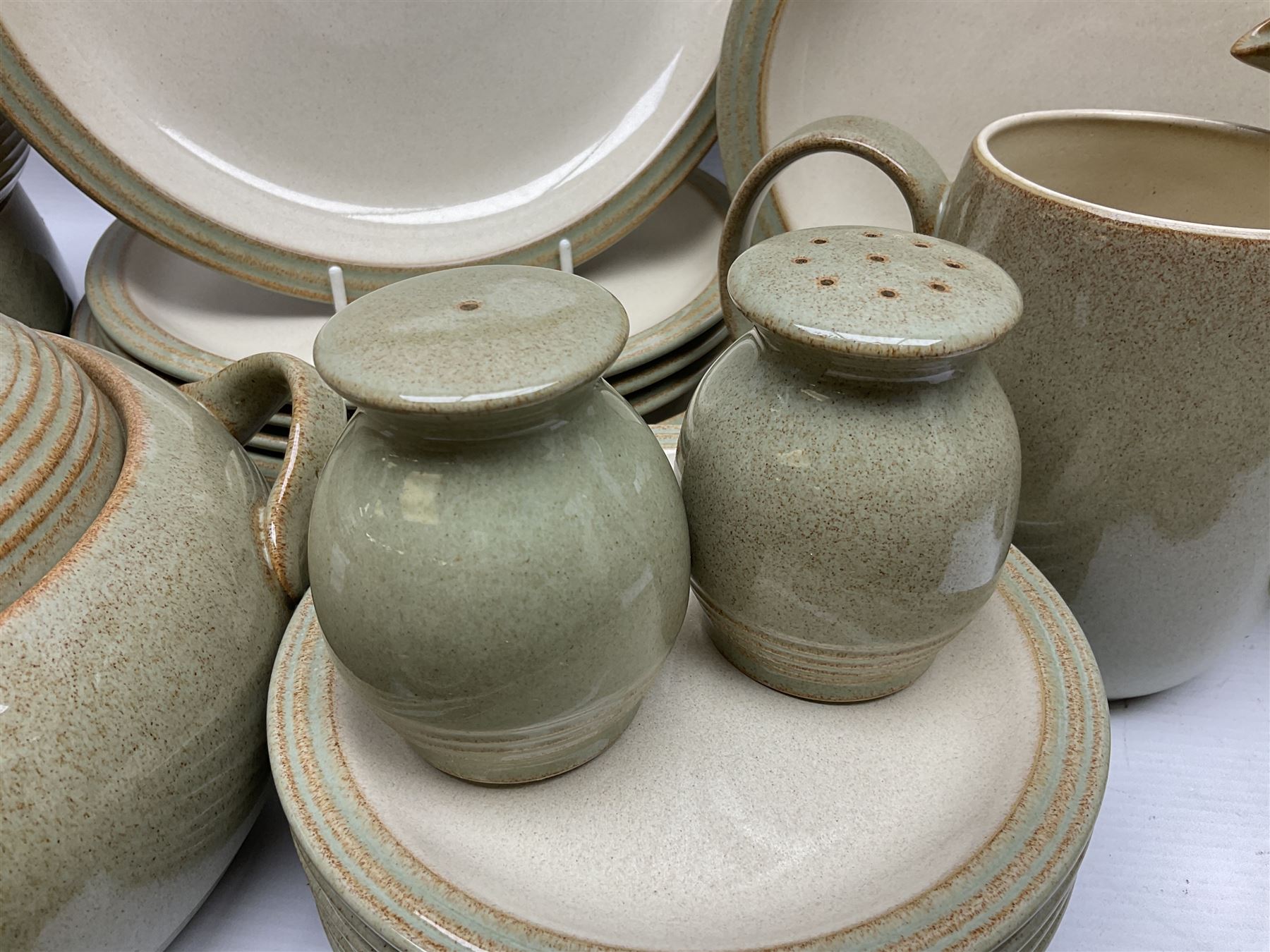 Denby tea and dinner wares, including bowls, jugs, tureens, side plates, dinner plates, serving dishes, cups and saucers, coffee pot, etc, all decorated with a green and brown mottled glaze, with printed marks beneath, in two boxes 