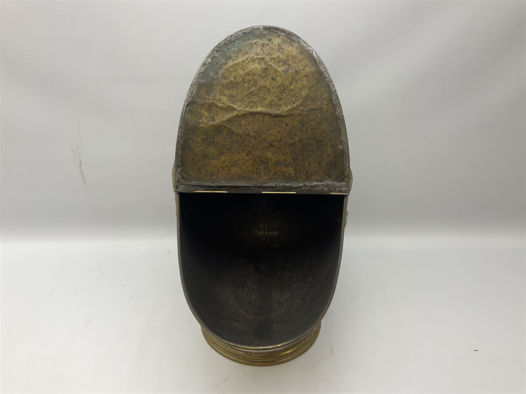 Victorian brass helmet shaped coal scuttle with embossed decoration and turned wooden handle and shovel, H49cm