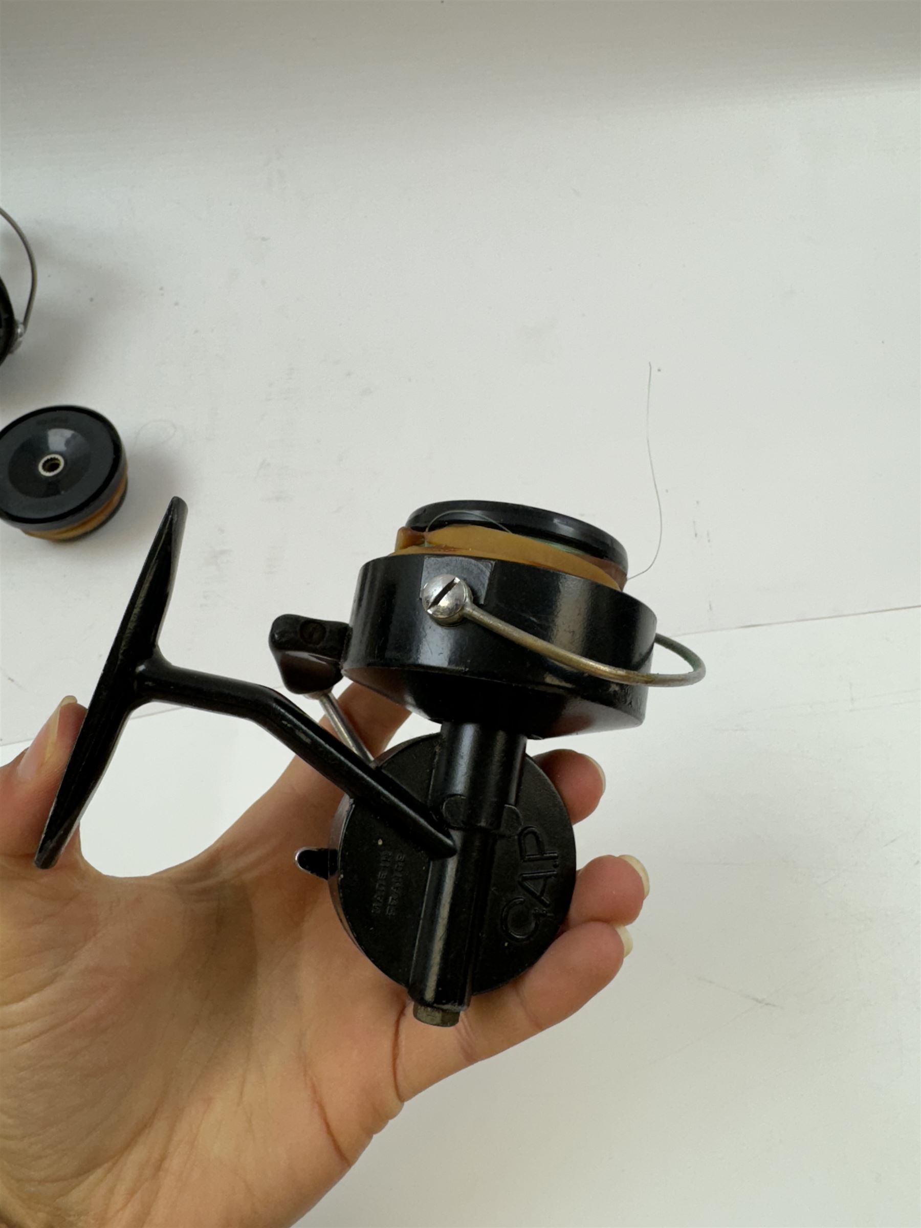 Four fishing reels, Winfield Beach fisher rod, Winfield International 20 , DAM International etc 