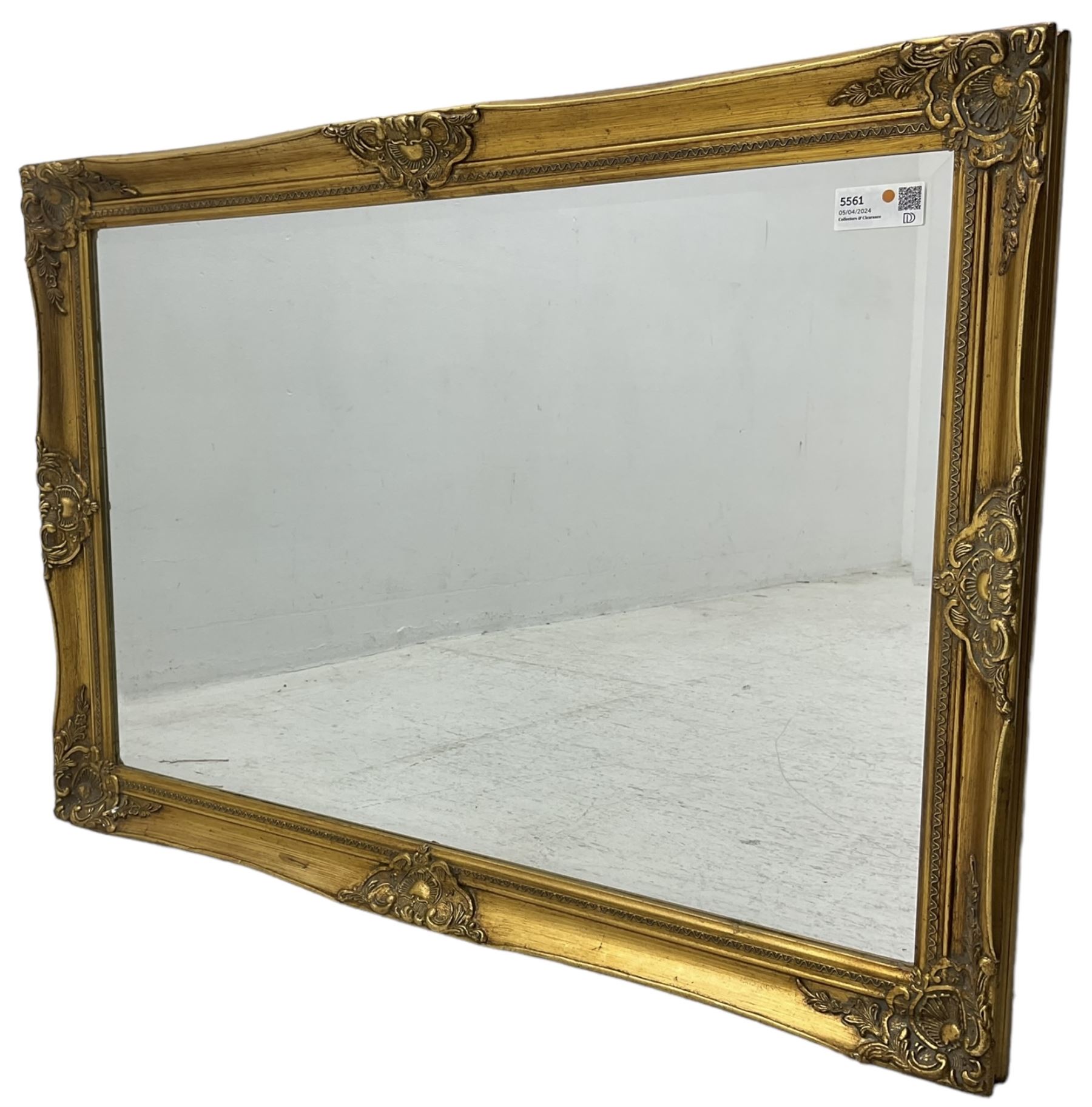 Swept gilt framed wall mirror with rectangular bevelled plate