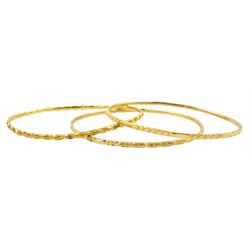 Three Middle Eastern 20ct and 21ct gold bangles