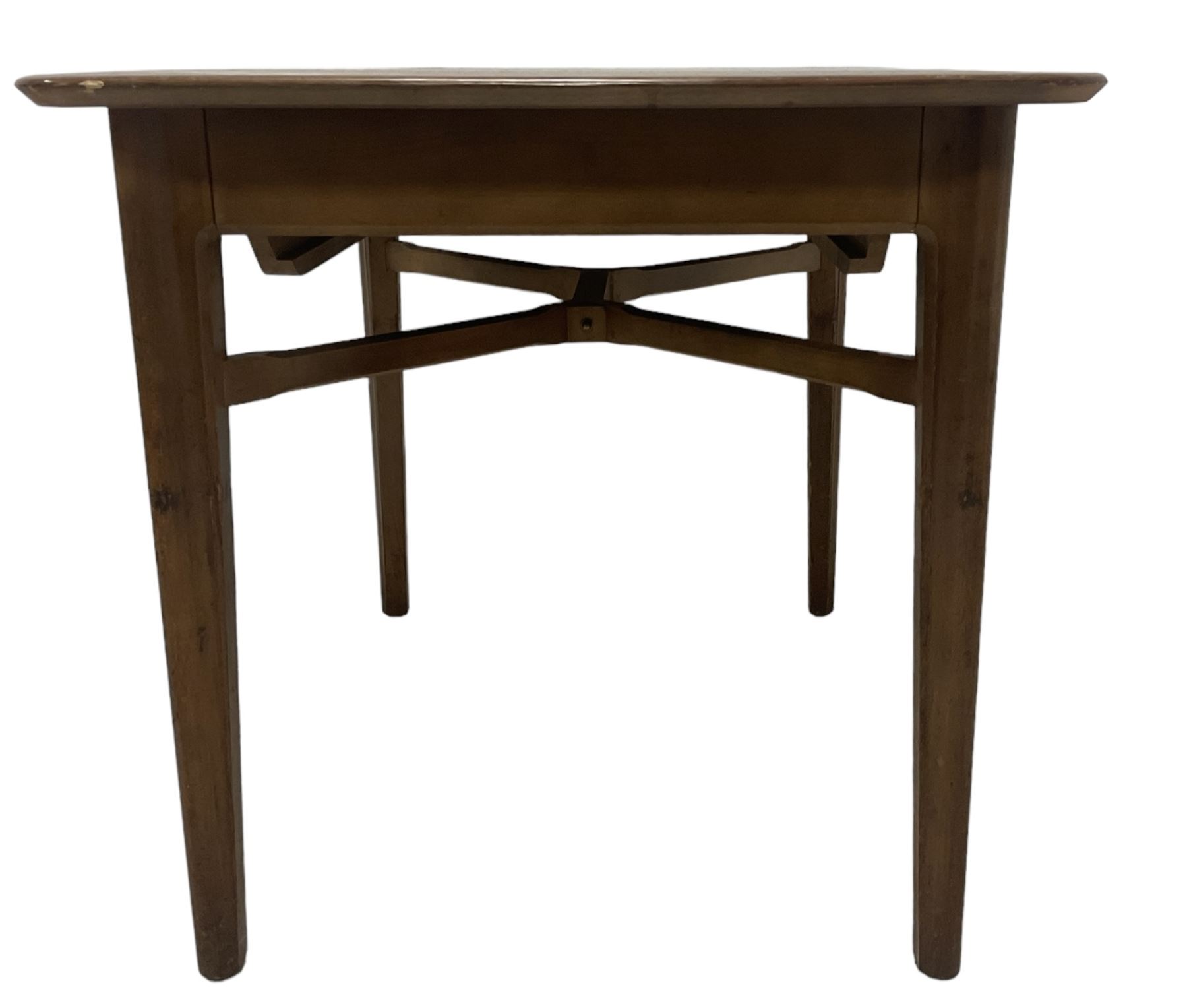 Mid-20th century teak extending dining table, rectangular top with rounded corners, raised on shaped tapering supports united by X-stretcher, with additional leaf