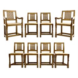 'Rabbitman' set of eight oak dining chairs, pierced lattice backs, upholstered seats with studwork band, octagonal front supports joined by stretchers, carved with rabbit signature, two carvers and six side chairs, by Peter Heap of Wetwang