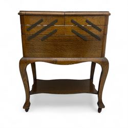 Early 20th century oak cantilever workbox, rectangular hinged lid enclosing divided interi...