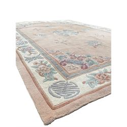 Chinese washed woollen pink ground rug, decorated with floral bouquets and Chinese symbols 