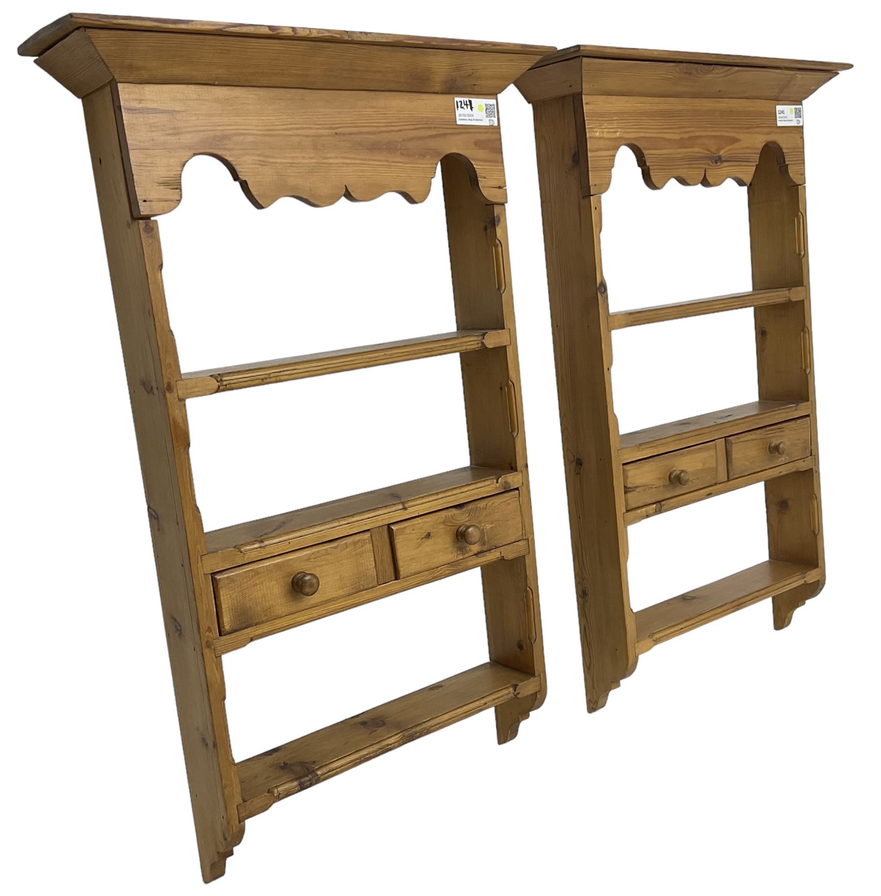 Pair of 20th century small waxed pine plate racks, shaped apron over three shelves and single drawer styled as two