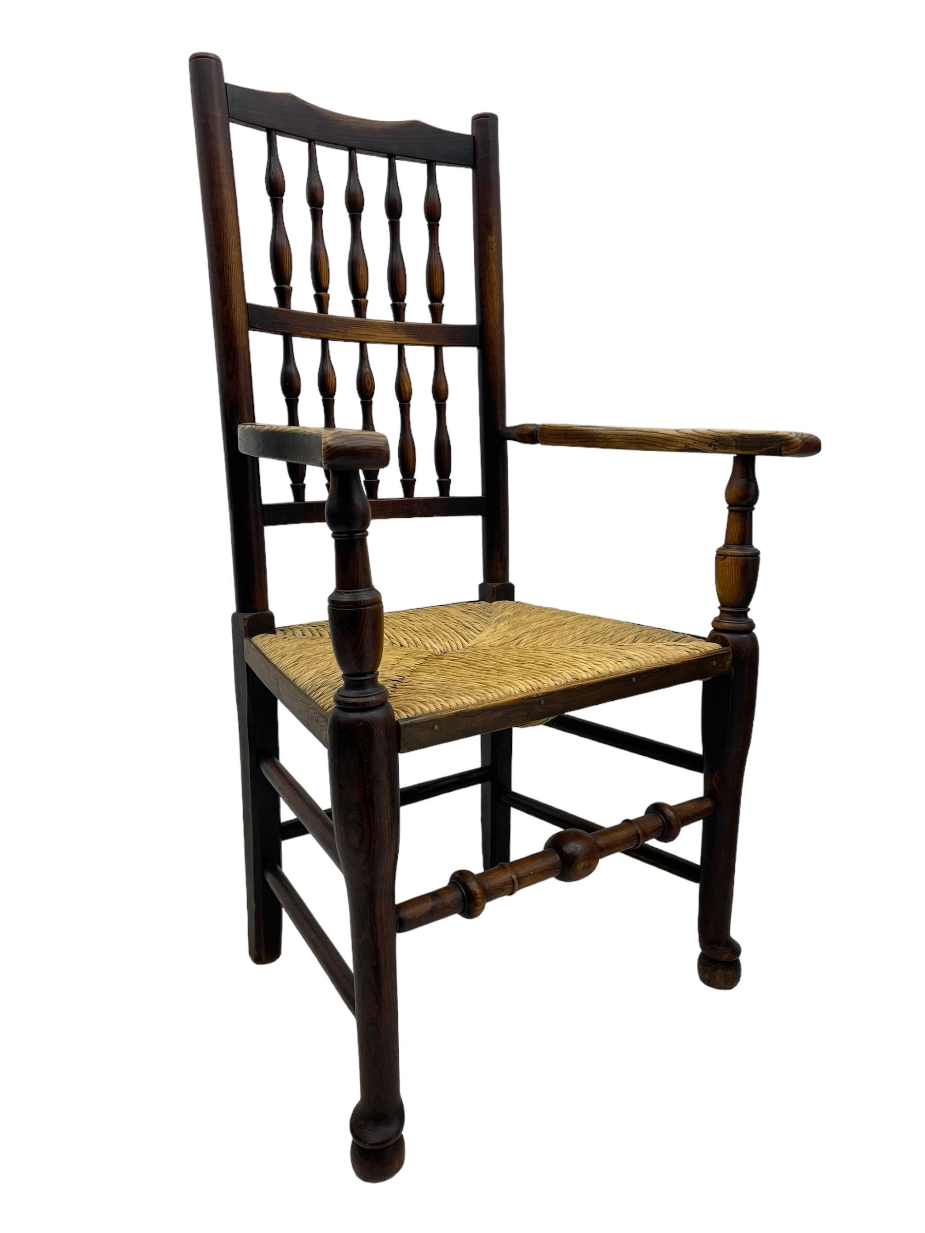 Matched set of twelve 19th century elm Lancashire spindleback dining chairs, shaped cresting rail over spindle back, rush seat, on turned supports united by turned stretchers, ring and globular turned front stretcher 