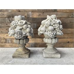 Pair of cast stone garden wall or gate finials depicting Fruit Piers, raised on separate c...