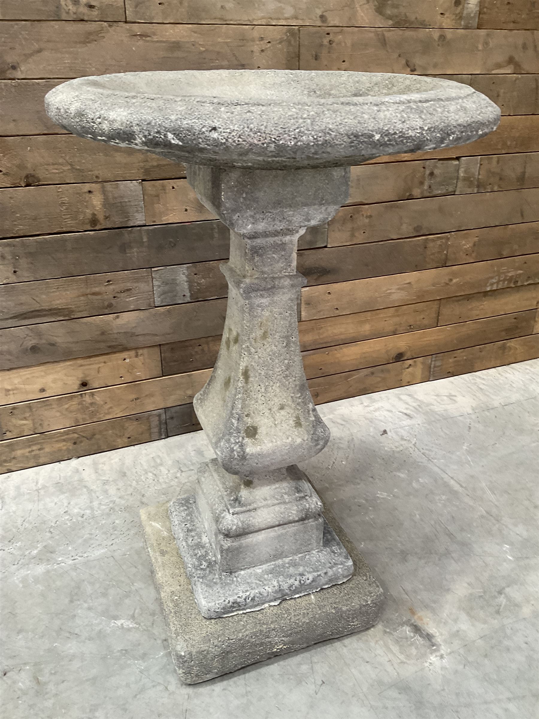 Cast stone garden bird bath, circular dished top, raised on square tapering column, on stepped base with separate mounting plinth