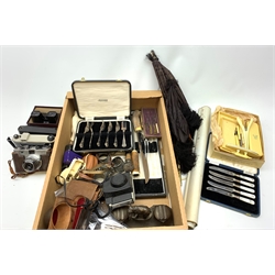 A group of assorted items, to include a selection of silver plated flatware by Roger Bros, a cased set of pastry forks, cased horn carving set, a pierced bottle stopper, pair of napkin rings, napkin ring with figural supports, cased drawing instruments set, desk tray with dual inkwells and pen recess surmounted with a model of an elephant, ivory dressing table set comprising two trays, clothes brush, glove stretcher, buffer, etc., a number of vintage cameras, View Master and slides, two folding parasols, etc. 