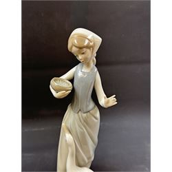 Four Lladro figures, including Girl with Lamb, Girl with Dove etc