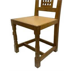 Mouseman - set of six oak dining chairs, pierced and carved lattice panel back over tan leather seat with studded band, on octagonal front supports united by plain H stretchers, carved with mouse signature, by the workshop of Robert Thompson, Kilburn 