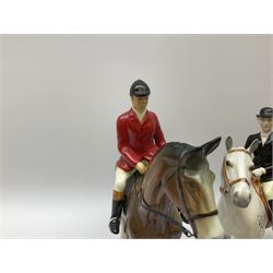 Beswick Hunting Group, comprising: two huntswoman on grey horses, model no 1730, huntsman on a bay horse, model no 1501, a seated fox, model no 1748, eighteen fox hounds and a spaniel, model no 967, all with printed marks beneath, together with three other ceramic huntsman on horseback and two hounds. 