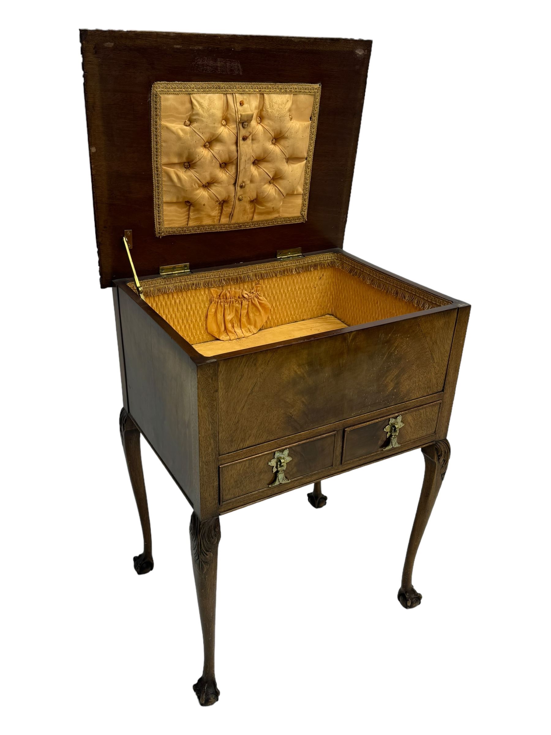 Early 20th century mahogany work table, hinged top enclosing satin-lined compartment with pincushion and pockets, lower section fitted with two drawers with dividers, on cabriole supports with carved knees and claw feet