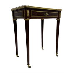 Late 19th century French figured plum pudding mahogany side table, canted rectangular white marble top with raised gilt metal gallery, fitted with a single frieze drawer, central extending floral cast ormolu escutcheon and applied moulded edging, on tapering turned and fluted supports with brass cups and castors, decorated with cast foliate mounts and foliate cast collars 