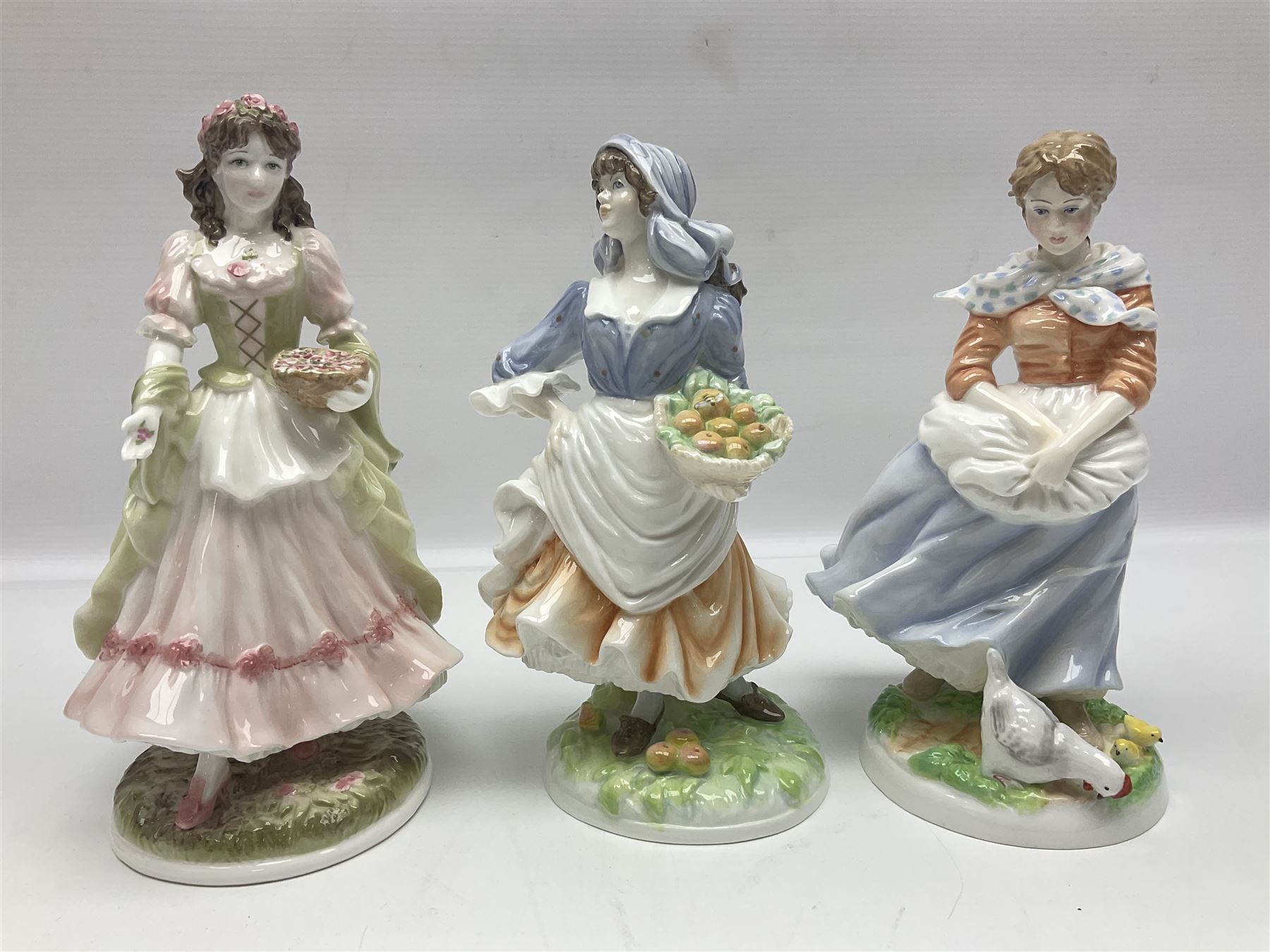 Five Royal Worcester figures, comprising The Queen of May, Rosie Picking Apples, A Farmers Wife, The Milkmaid and The Shepherdess, all with printed marks beneath and some with certificates of authentication   