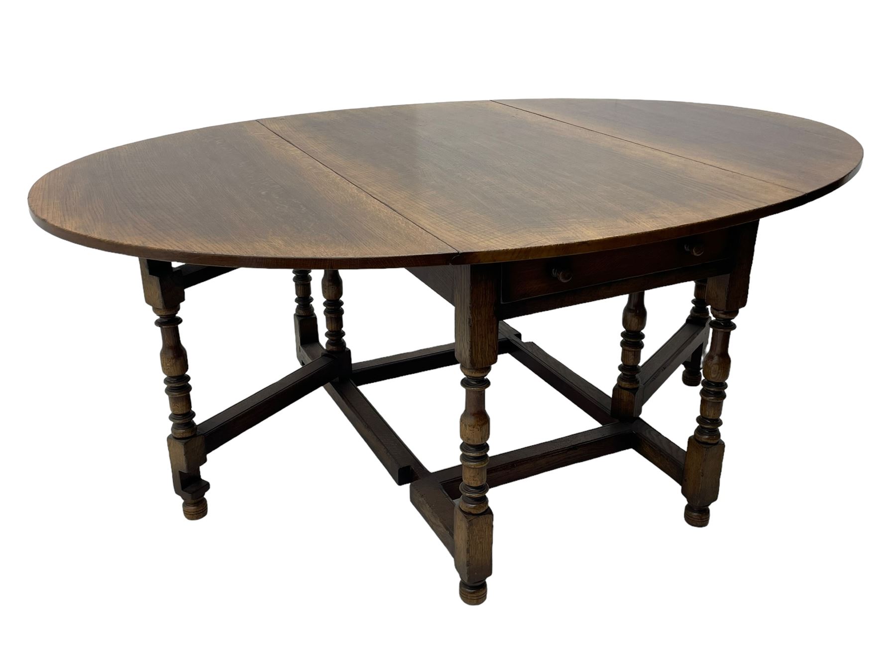 Titchmarsh & Goodwin - 17th century design oak drop leaf dining table, oval top with hinged drop leaves, single drawer to one side with applied makers label, baluster-turned supports united by stretchers