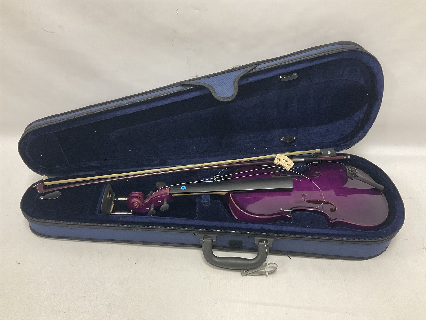 Intermusic 3/4 violin with a violet coloured solid wood body, ebonised fingerboard and fittings, bow and hard case, length 54cm