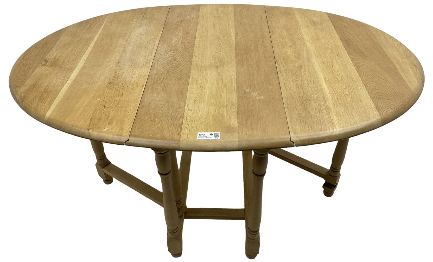 Contemporary oak and beech dining table, oval drop-leaf top on turned supports united by stretchers, gate-leg action base