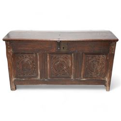 18th century carved oak coffer or chest, sloped hinged lid over panelled front, carved with three Northern European portraits with foliage surrounds decorated with birds, fitted with wrought metal carrying handles, on fluted stile supports 