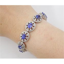 18ct white gold tanzanite and diamond bracelet, twelve oval link clusters set with oval cut tanzanite's and round brilliant cut diamonds, stamped 750, total tanzanite weight approx 11.00 carat, total diamond weight approx 3.65 carat