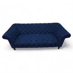 Chesterfield three-seat sofa, traditional shape with rolled arms, upholstered in deep blue buttoned fabric, on black finish turned front feet 