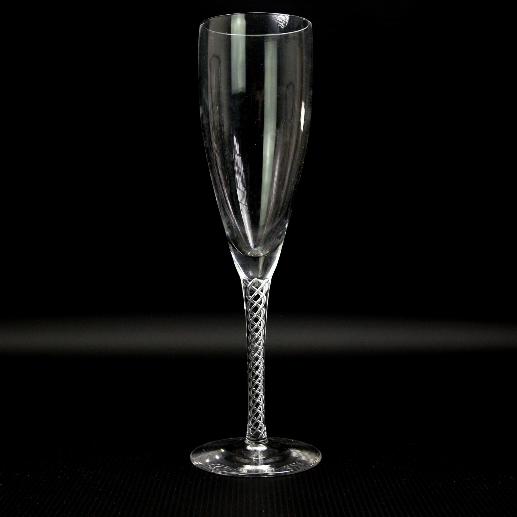 Part suit of Stuart Ariel drinking glasses comprising eight champagne flutes, six white wine glasses and two red wine glasses, together with a Saint Louis heavy cut glass vase, H25cm