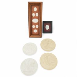 Seven plaster medallions within a wooden frame, together with another framed medallion, pa...