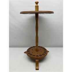 Pine stick stand, with turned central column dividing two circular tiers, upon three feet, with capacity for twenty four walking sticks, H73cm