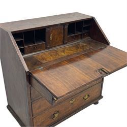 George I figured walnut bureau, hinged fall front enclosing drawers, pigeon holes and slide revealing storage well, fitted with four long cock-beaded and graduating drawers, shaped brass handle plates and escutcheons, on turned bun feet 