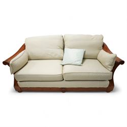 Multi-York - French cherry wood framed two seat bergere settee, back and loose cushions upholstered in sage green lozenge patterned fabric, flanked by scrolled arm terminals over double-caned sides, on compressed bun feet