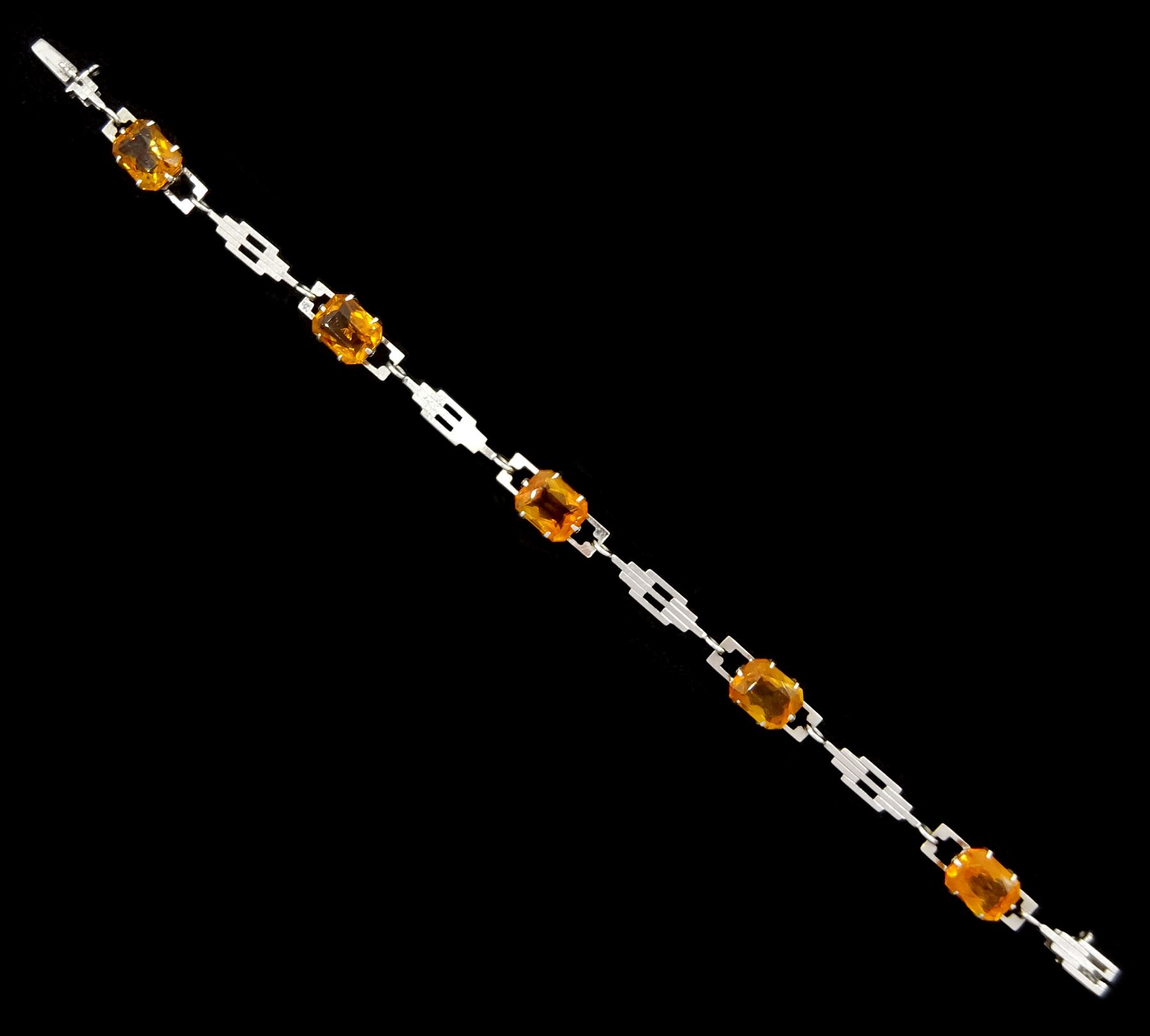 White gold citrine bracelet, five octagonal cut citrines, spaced by gold geometric links, stamped 9ct, markers mark RP Ltd