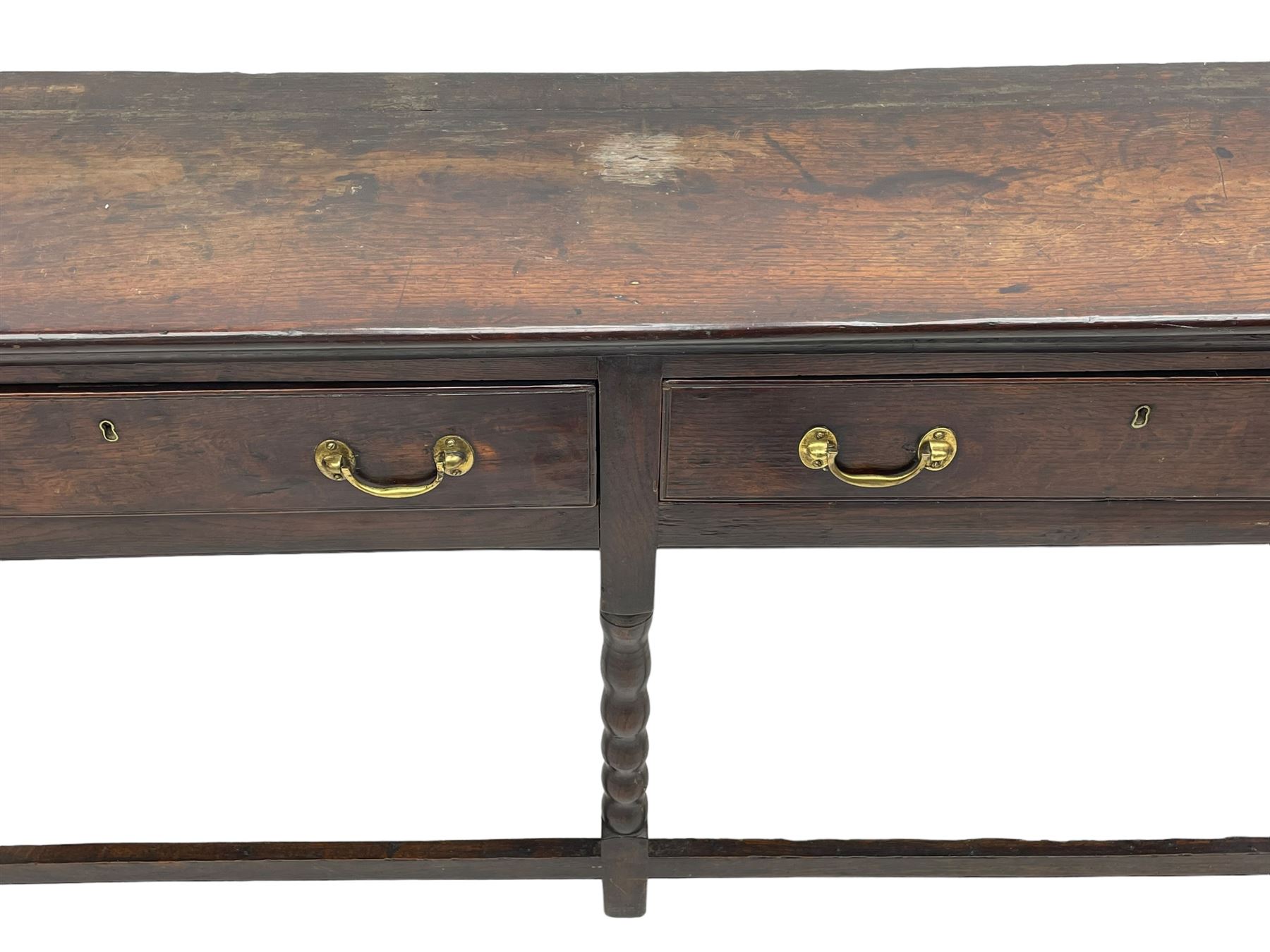 18th century oak dresser base, rectangular top, fitted with two drawers with moulded facia edges and brass swan neck handles, raised on turned front supports united by stretchers