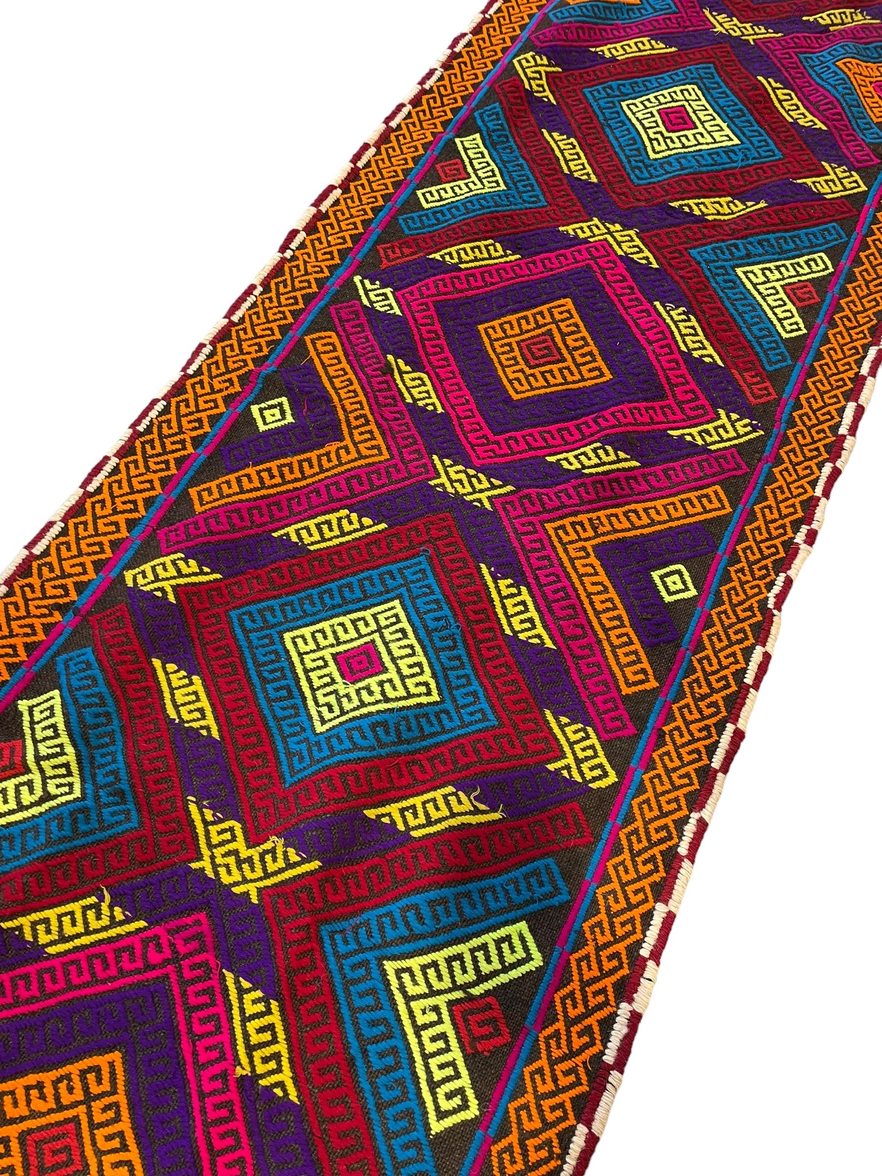 Flatweave geometric design runner rug, decorated with trailing lozenges decorated with hooked motifs, within zig-zag bands, bright multi-coloured ground 