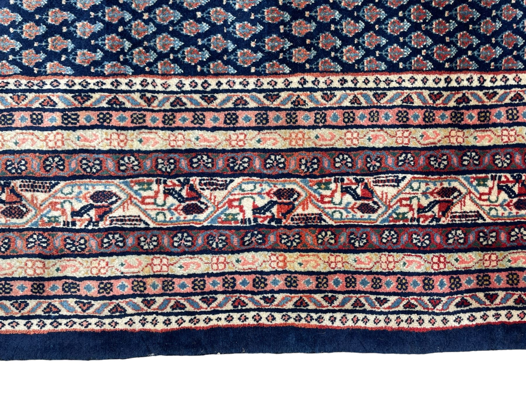 Large North-West Persian Arrak indigo ground carpet, the field decorated all-over with small Boteh motifs, multiple band border decorated with repeating geometric designs