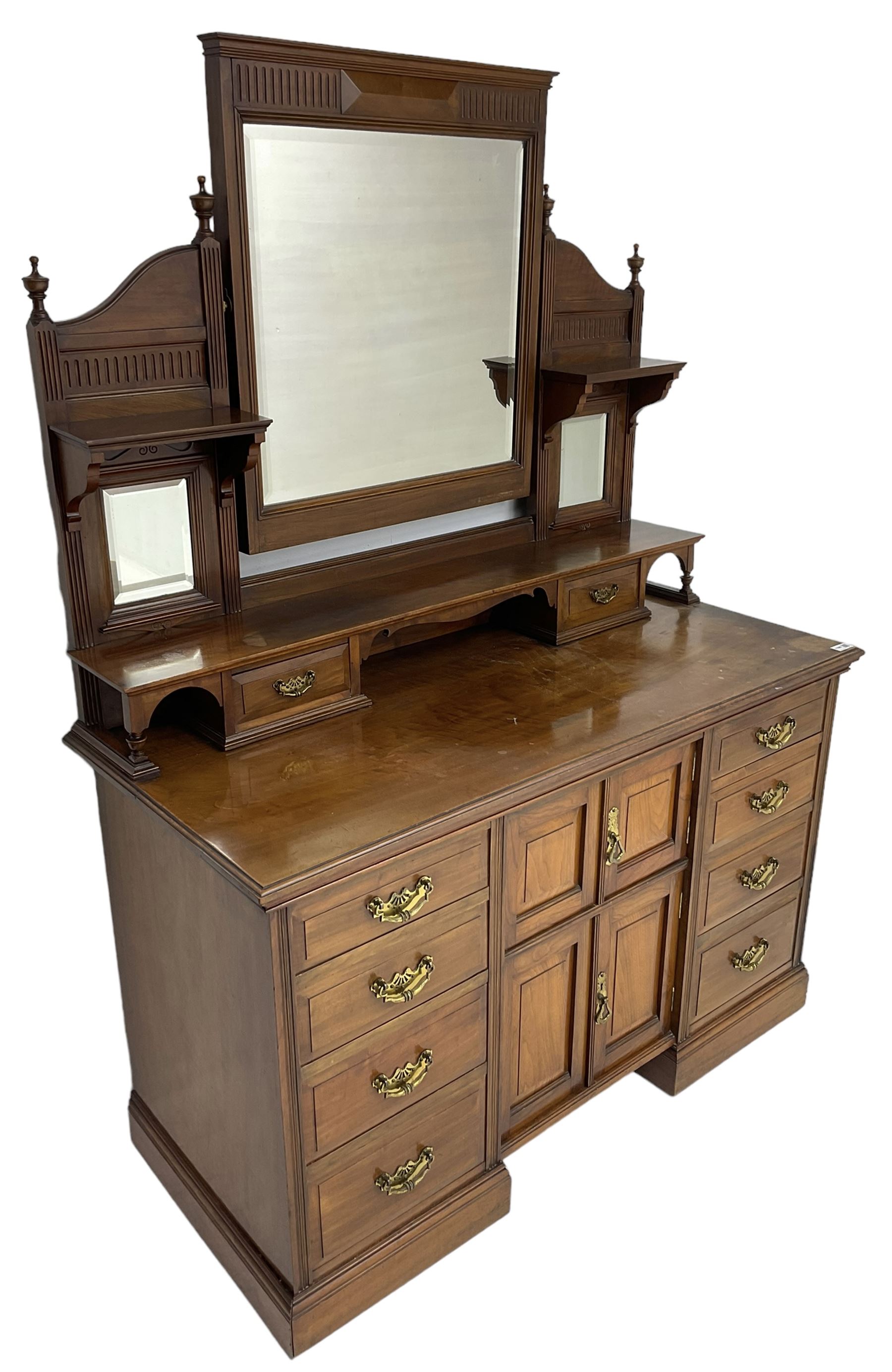 Edwardian mahogany dressing chest, raised triple mirror back with bevelled plates and fluted decoration over two trinket drawers, the base fitted with two central cupboards flanked by four graduating drawers to each side