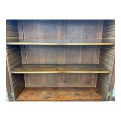 Early 19th century mahogany bureau bookcase, the projecting cornice over two Gothic-style astragal glazed doors enclosing two adjustable shelves, sloped hinged lid enclosing fitted interior and felt inset, four graduating drawers, on bracket feet