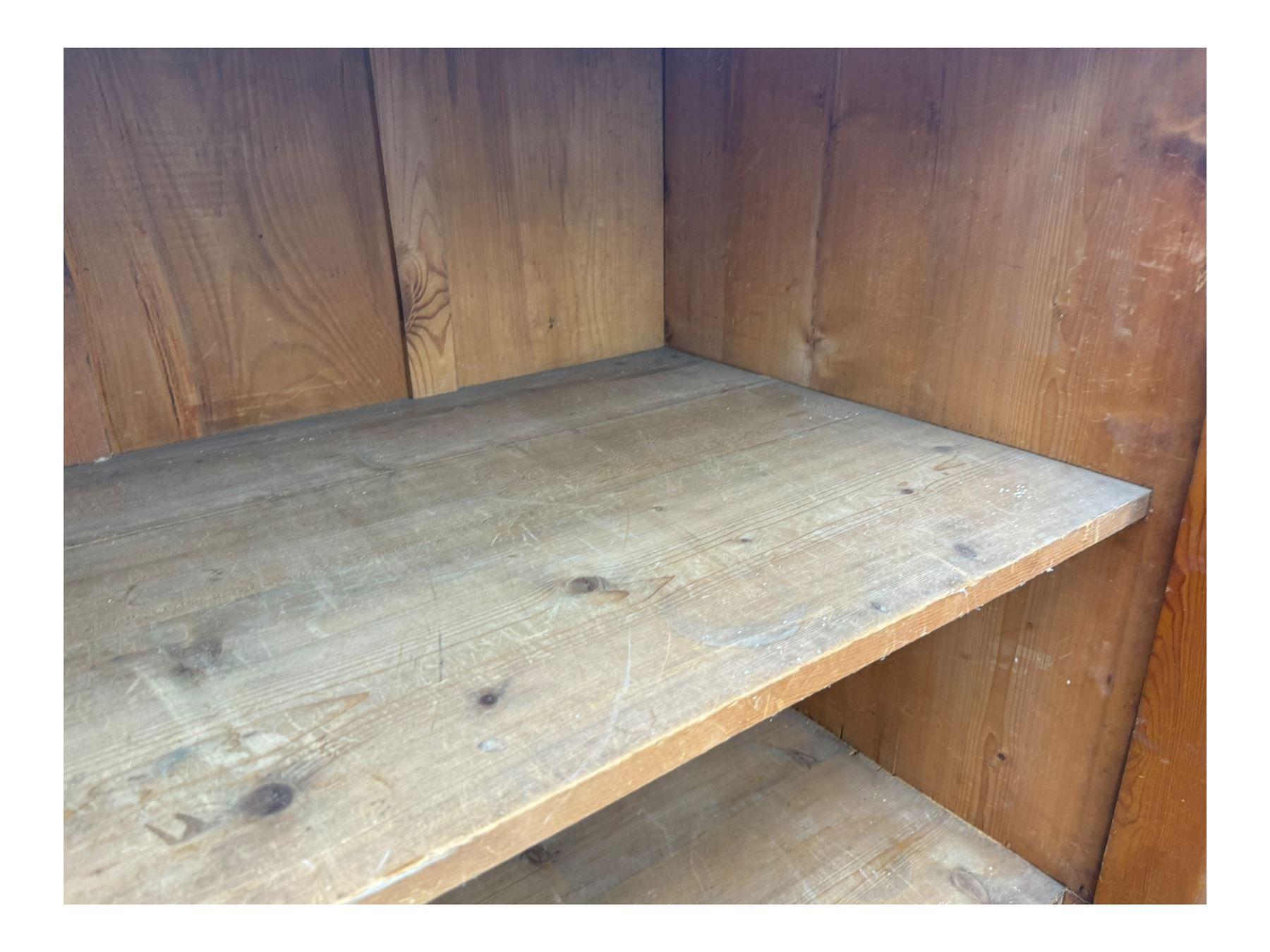 Large 19th century pine cupboard, rectangular top over two panelled later doors, enclosing four open shelves, on plinth base