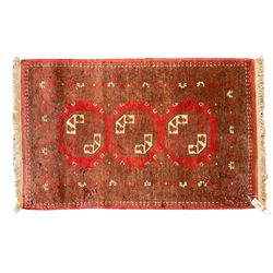 Persian Hamadan crimson ground rug (155cm x 105cm); Persian crimson ground rug (265cm x 130cm); small Bokhara red ground rug (118cm x 75cm)