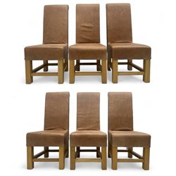 Set of six contemporary light oak dining chairs, each with high back and seat upholstered in pale tan leather, on square supports connected by H-stretcher