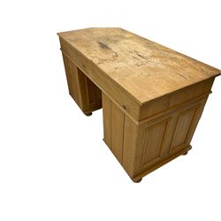 Waxed pine twin pedestal desk, rectangular top over nine drawers, on compressed bun feet 