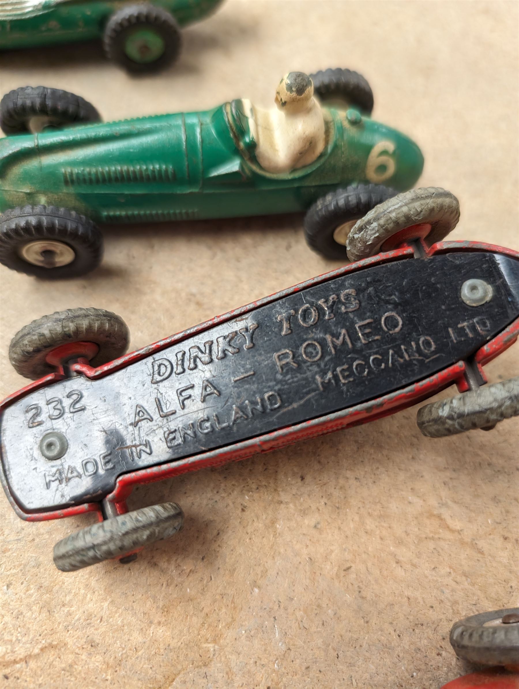 Four Dinky race cars, to include Cooper Bristol, two Alfa Romeos and a Vanwall