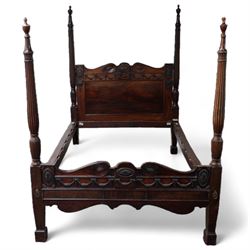 19th century and later Hepplewhite design mahogany four poster double bed, urn finials atop reeded and turned pilasters, head and footboard decorated with carved and moulded floral festoons and acanthus rosettes, shaped apron over shaped supports and square feet