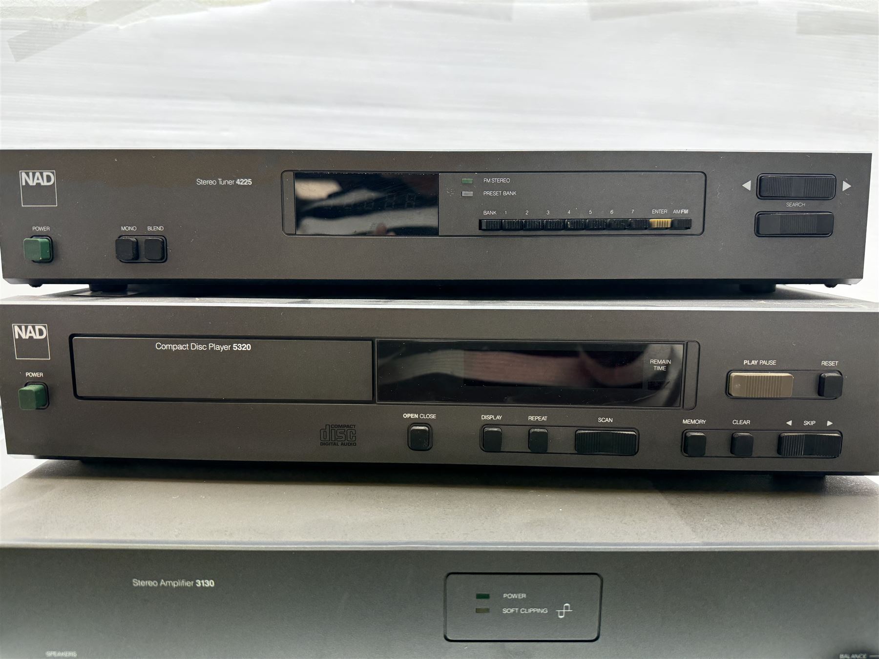 Three NAD Hi-Fi audio stacking system separates, comprising 3130 stereo amplifier, 4225 stereo tuner and 5320 compact disc player 