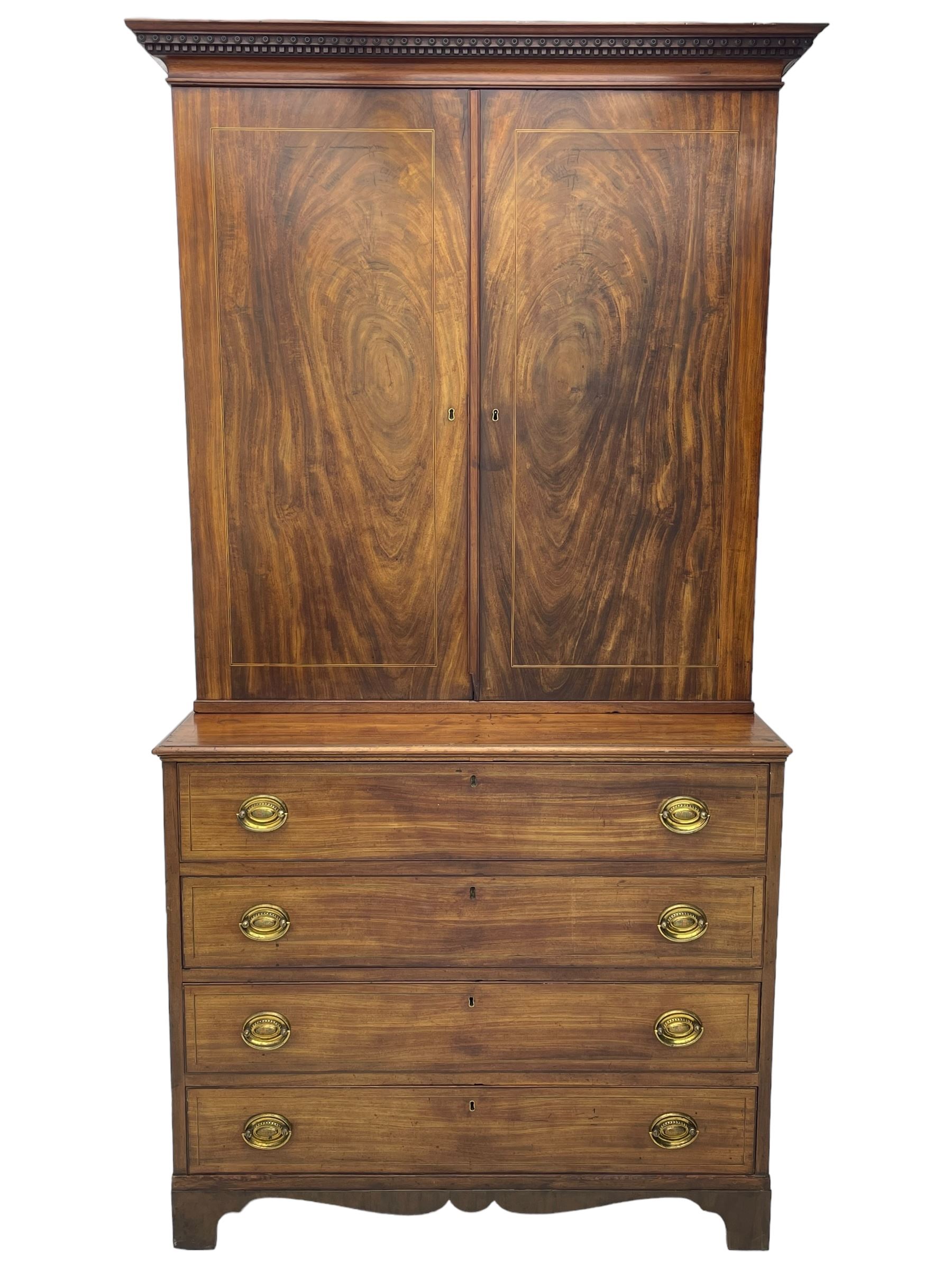 George III figured mahogany secretaire bookcase, projecting moulded dentil cornice decorated with single row of roundels, two figured mahogany doors with boxwood and ebony stringing enclosing three adjustable shelves and three drawers, moulded rectangular top over four long scratch-moulded drawers, the top secretaire drawer with fall front enclosing small drawers, pigeon holes and inset writing surface, shaped apron with bracket feet