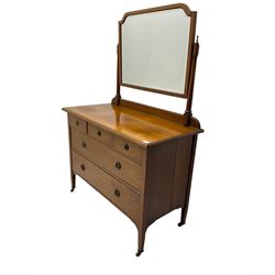Early 20th century walnut dressing chest, swing mirror back, fitted with three small drawers above two long drawers, on brass and ceramic castors